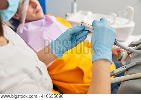 Medic Carefully Spreading Prophy Paste On Polishing Brush