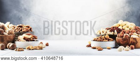 Assortment Of Nuts In Bowls. Cashews, Hazelnuts, Walnuts, Pistachios, Pecans, Pine Nuts, Peanuts, Ma