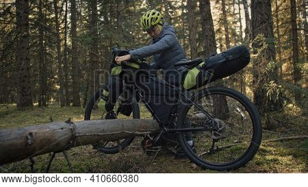 The Woman Travel On Mixed Terrain Cycle Touring With Bike Bikepacking. The Traveler Journey With Bic