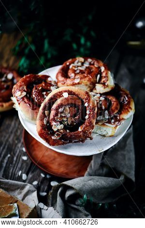 Brunost Caramel Cinnamon Buns A Wooden Table . Dark Rustic Photo.selective Focus
