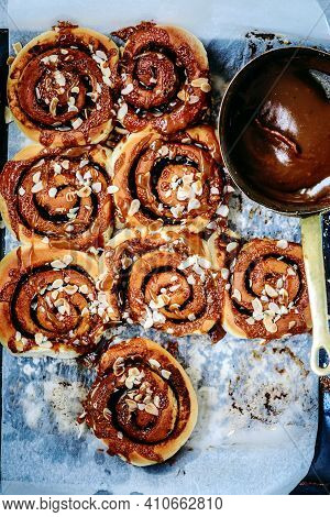 Brunost Caramel Cinnamon Buns A Wooden Table . Dark Rustic Photo.selective Focus