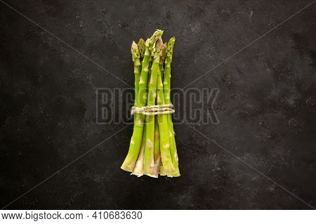 Bunch Of Asparagus Tied With Jute Rope On Black Or Dark Grey Background.