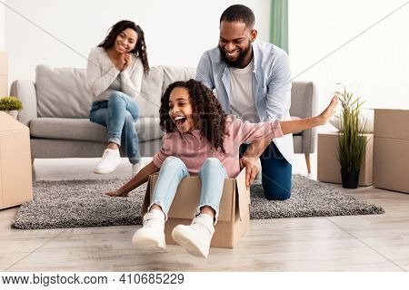 New Home, People And Real Estate Concept. Excited African American Family Having Fun And Celebrating