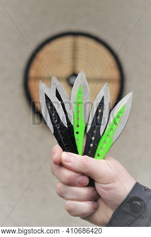Throwing Knives. Sport And Hobby . Throwing Knives Close-up And A Target On The Wall.outdoor Sports.