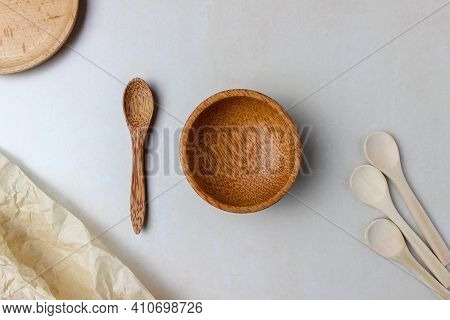 Wooden Utensils On The Kitchen Table. Round Wooden Plates, A Wooden Spoon. The Concept Of Serving, C