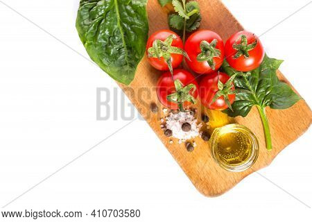 Tomatoes With Spinash And Spices With Olive Oil Isolated On A White With Copy Space.