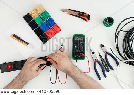Electrician Checking Socket Voltage With Digital Multimeter