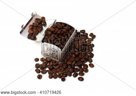 Roasted Coffee Beans In A Small Metal Chest Around It. Isolate On A White Background. Copspace