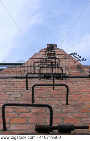 Old And Rusty Fire Escape On The Facade Of A Residential Building. The Building Was Built In The Las