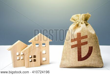 Turkish Lira Money Bag And Residential Buildings. Mortgage Loan. Property Tax. Investment In Real Es