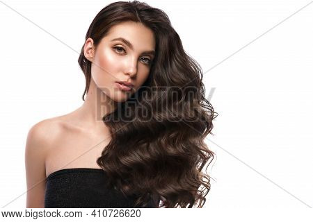 Beautiful Brown-haired Girl With A Perfectly Curls Hair, And Classic Make-up. Beauty Face And Hair.