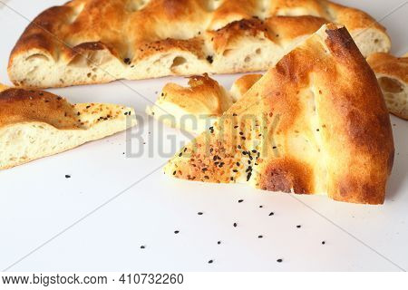 Slices Of Ramadan Pita (ramazan Pidesi) Traditional Turkish Bread For Holy Month Ramadan On White Ba