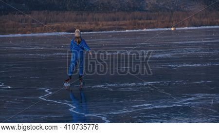The Child Train On Ice Professional Speed Skating. The Girl Skates In The Winter In Sportswear, Spor
