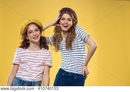 Funny Mom And Daughter Wearing Hats Fashion Fun Joy Family Yellow Background