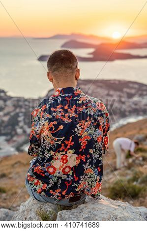 Tourist Admire Sunset Over Dubrovnik Old Town Adriatic Islands Coastline In Summer From Mountain Srd
