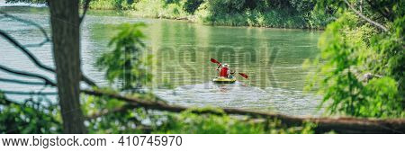 Kayak in summer nature lake lansdcape panoramic of outdoor watersport. Man kayaking in Canada banner.