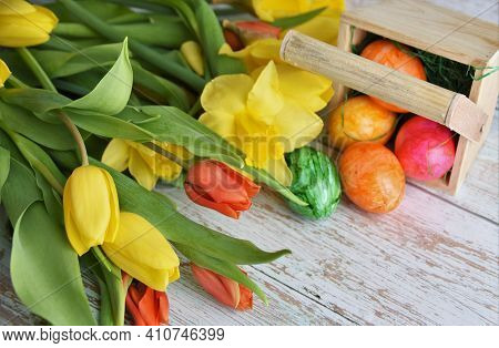 Yellow Tulips, Daffodils And Painted Easter Eggs