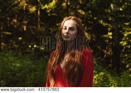 The Young Woman In Red Dress In Green Rainfores. Concept Of Nature And Happy Life, Adventure. Beauti