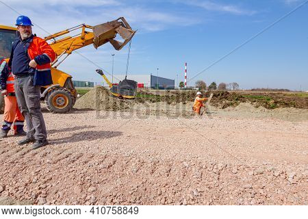 Zrenjanin, Vojvodina, Serbia - March 30, 2018: Excavator Is Carry, Over Building Site With Raised Up