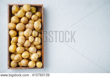 Baby Potatoes Small Round Potato From India Set, In Wooden Box, On White Stone  Background, Top View