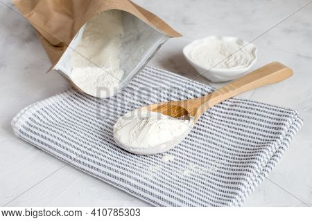 Crumbly Xanthan Gum In A Wooden Spoon.