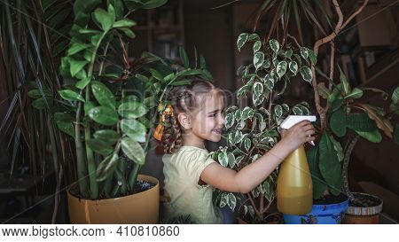 Cute Girl Helping To Care For Home Plants On The Window, Plant Parents Concept, Home Gardening, Gree