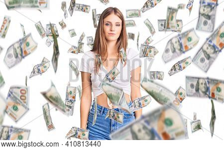 Young beautiful blonde woman wearing casual white tshirt relaxed with serious expression on face. simple and natural looking at the camera.