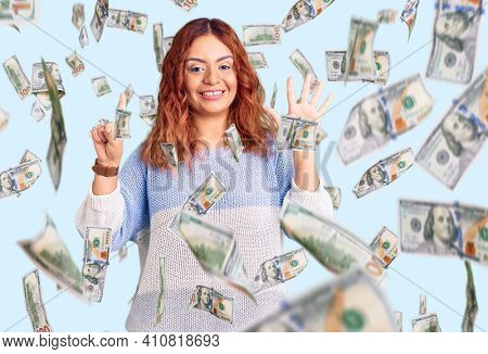 Young latin woman wearing casual clothes showing and pointing up with fingers number six while smiling confident and happy.