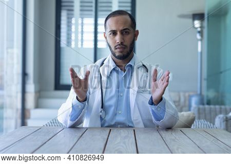 Portrait of caucasian male doctor looking at the camera. Professional medical worker wearing stethoscope and lab coat.