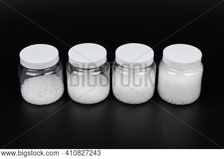 Transparent Bottle Inside With Plastic Beads. White Polymer. White Plastic Beads.