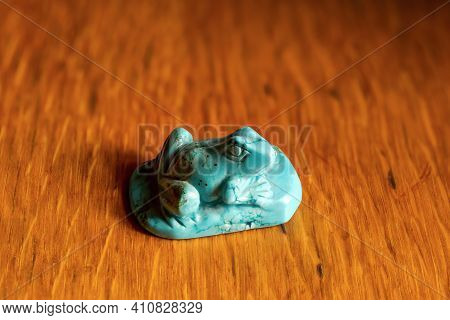 Beautiful Figurine Of A Frog Made Of Decorative Stone On A Wooden Table.