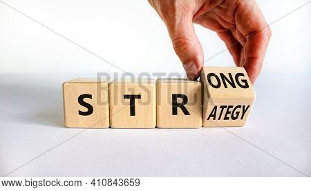 Strong Strategy Symbol. Businessman Turns A Wooden Cube With Words 'strong Strategy'. Beautiful Whit