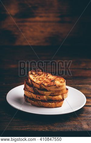 French Toasts On White Plate Over Wooden Surface