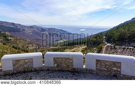 Panoramic Green Landscape With Green Plants, Rocks And Blue Sky With Sun Flare. La Morcuera, Madrid.