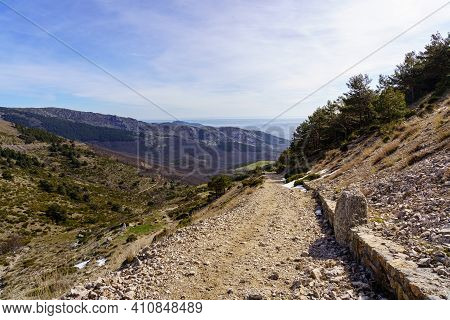 Panoramic Green Landscape With Green Plants, Rocks And Blue Sky With Sun Flare. La Morcuera, Madrid.