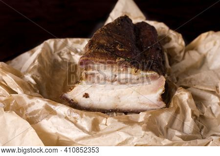A Piece Of Baked Meat With Layers Of Bacon, Cut From The Bottom Of A Pork Carcass, Along With The Sk