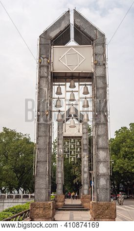 Guilin, China - May 11, 2010: Li River Downtown. Looking Through 2 Gray Stone Clock Towers Under Sil