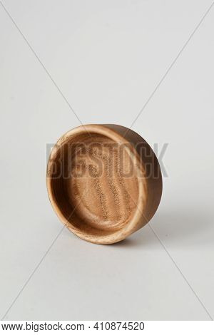 A Small Round Wooden Bowl On A White Background. Wooden Dishes With Their Own Hands.