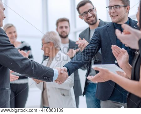 Businessteam is introducing a colleague to another businessman