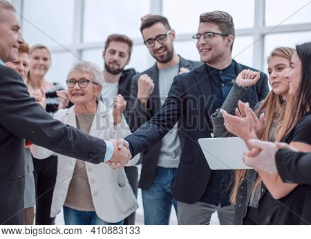 Businessteam is introducing a colleague to another businessman