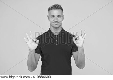 Satisfactory Result. Happy Man Show Double Ok Signs Yellow Background. Satisfied Guy Smile With Sati