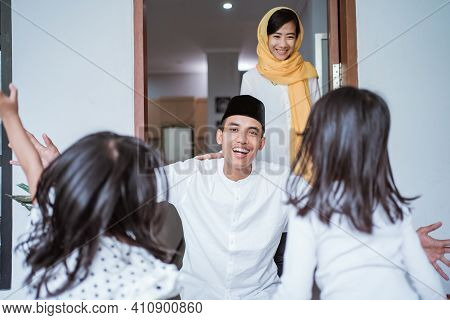 Excited Father Hug And Embrace His Children During Eid Mubarak Celebration