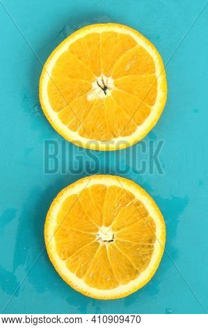 Close Up Of Two Round Orange Citrus Slices On Blue Background, Fresh Summer Mood. Stock Photo Blank 