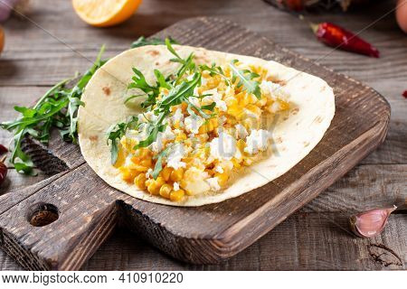 Birria Tacos With Egg, Corn, Cheese And Vegetables On A Wooden Table