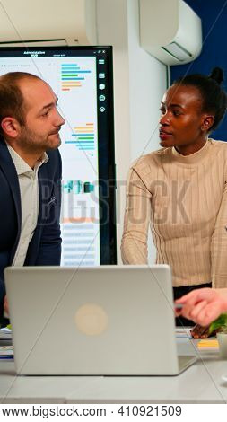 International Business Team Talking To African Woman Mentor Discussing Company Development Plan Stan