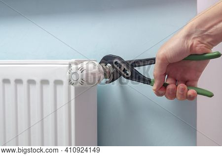 Plumber Fixing Radiator With Wrench. Heating Radiator With Temperature Regulator, Thermostat.