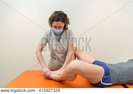Physiotherapist And Patient In Global Postural Re-education Session, With Pandemic Protection Mask.