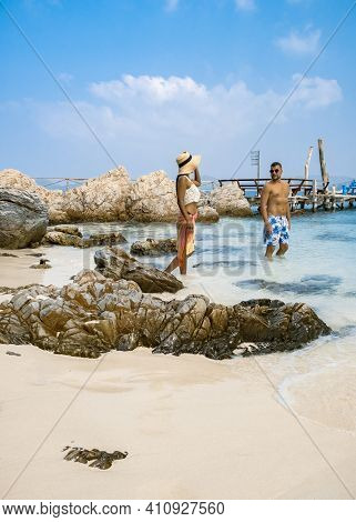A Couple From Behind On The Backside Looking Out Over The Ocean Of Tropical Island, Men And Woman Va