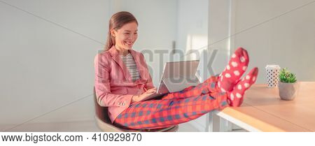 Working from home Asian woman streaming videoconference online in pajamas with suit blazer for remote work. Funny pandemic lifestyle concept panoramic banner.