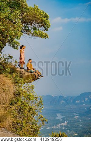 Couple Mid Age Men And Woman Trekking In The Thai Jungle Near Krabi Hiking To The Top Of Khao Ngon N